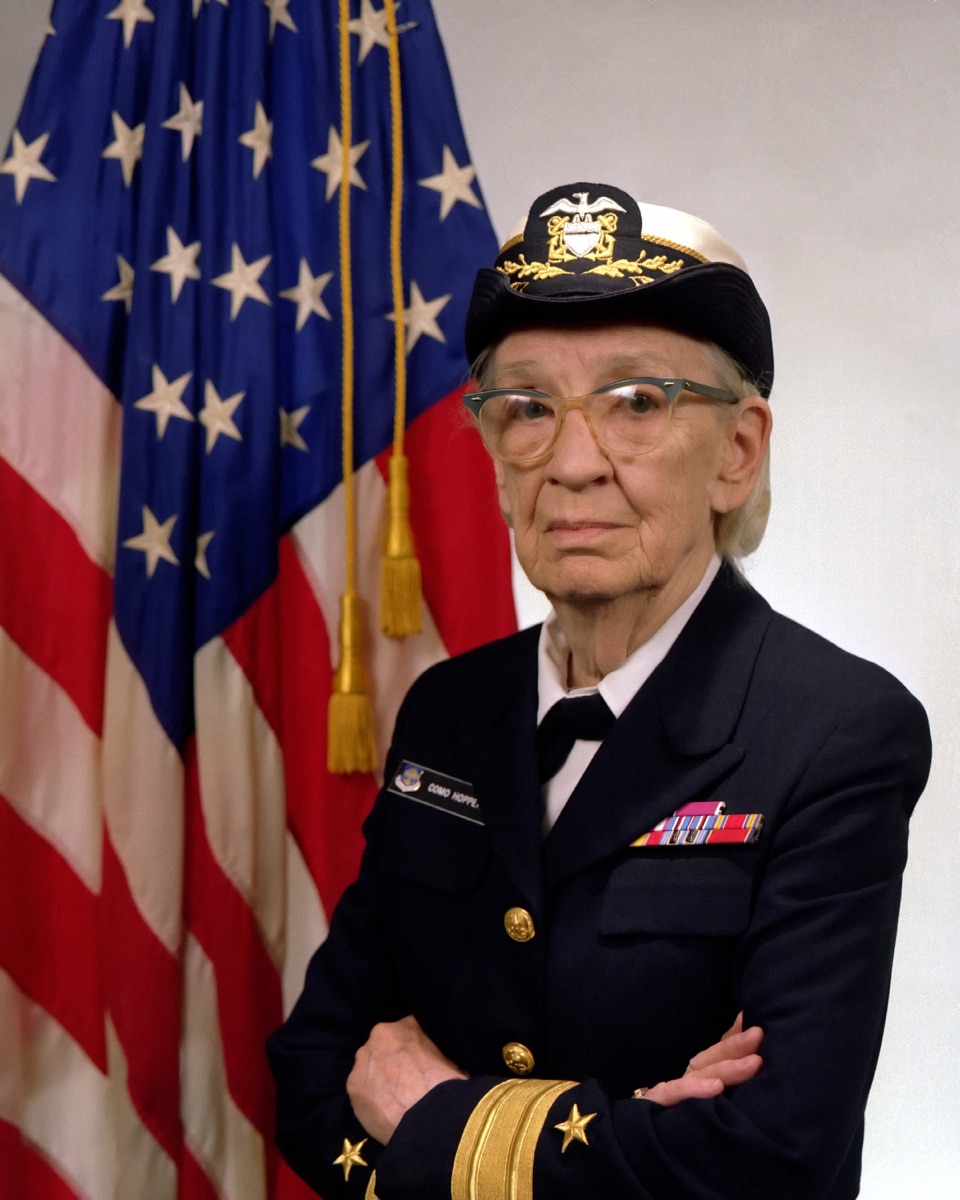 Commodore Grace M. Hopper in US Navy uniform, seated.
