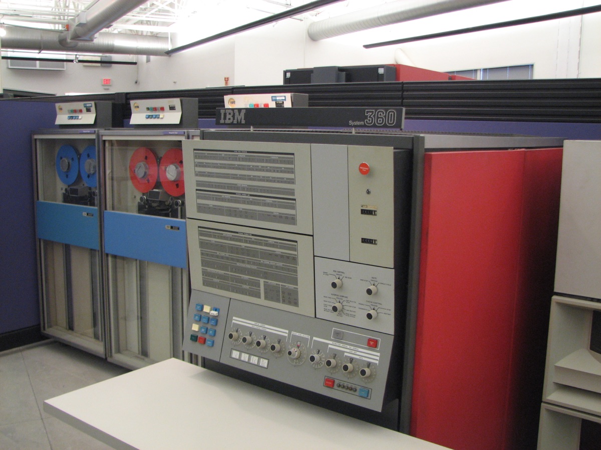 An IBM System/360 mainframe: several tall cabinets and a control console.