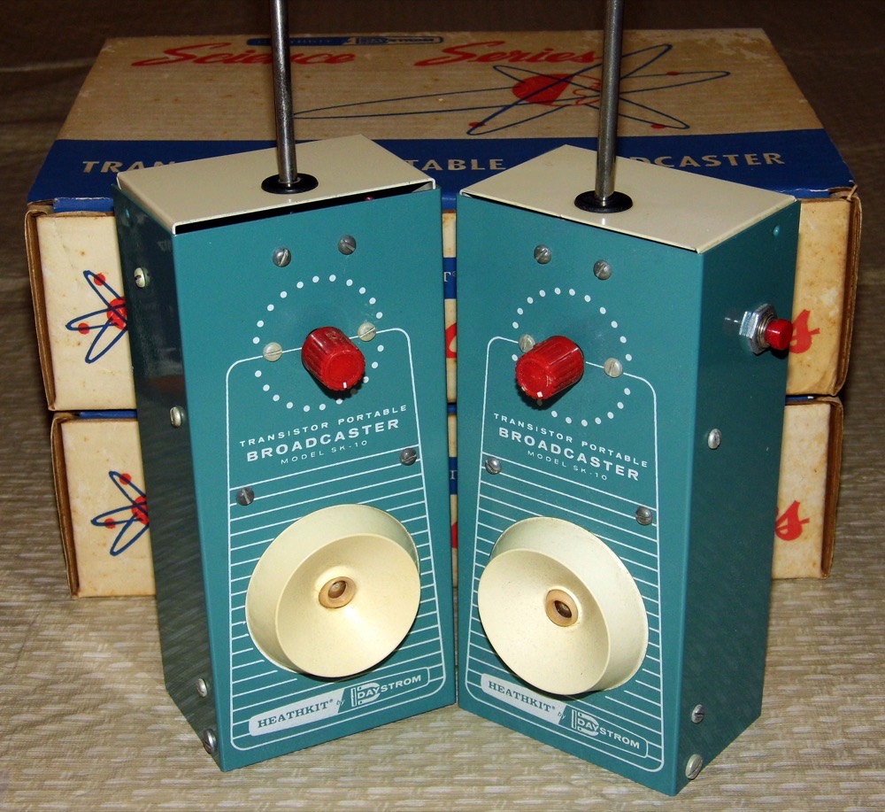 A matched pair of vintage 1960s Heathkit transistor walkie-talkies, sitting side by side.